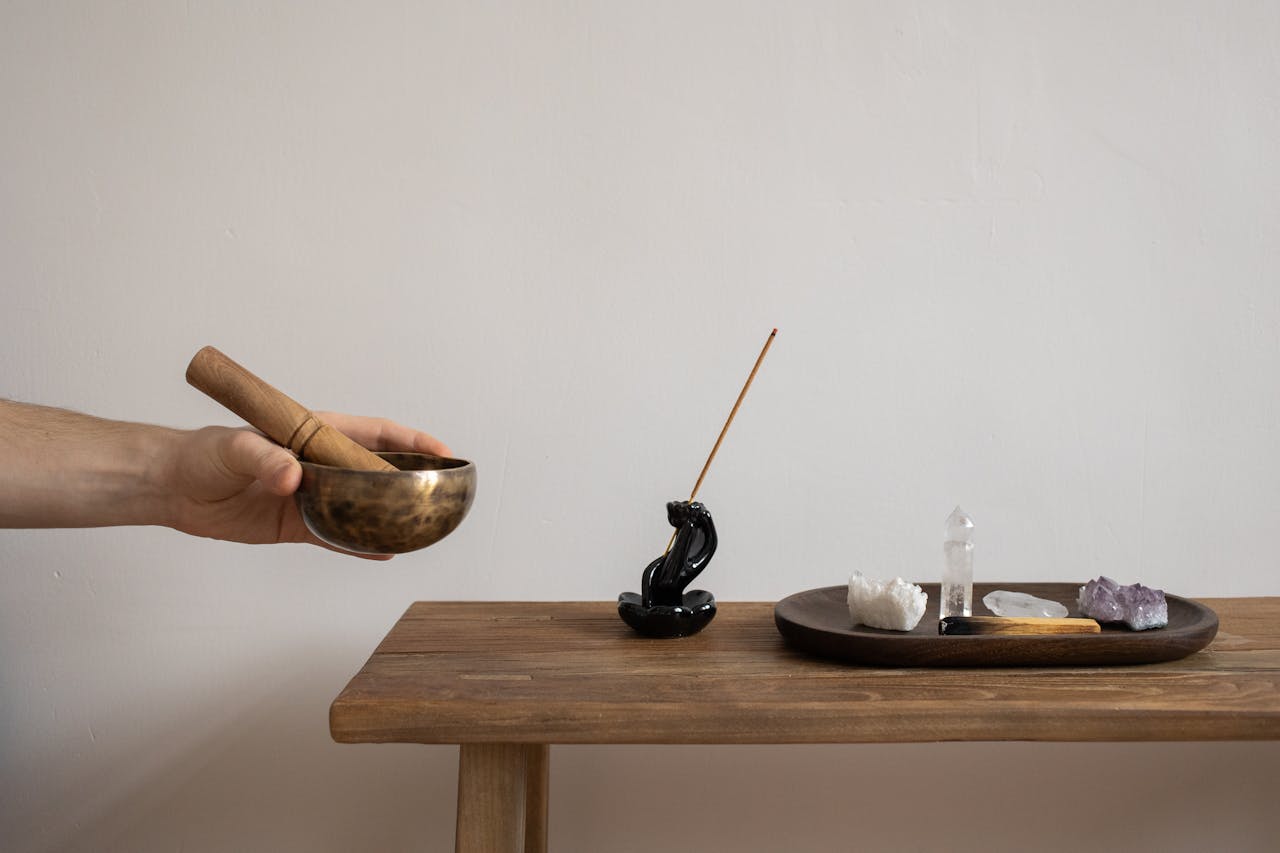 Serene setup featuring mortar, pestle, and crystals for mindfulness and spirituality.